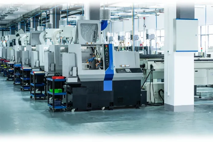 A CNC shop: a row of turning machines along the bay, tool trolleys parked between them (photograph)